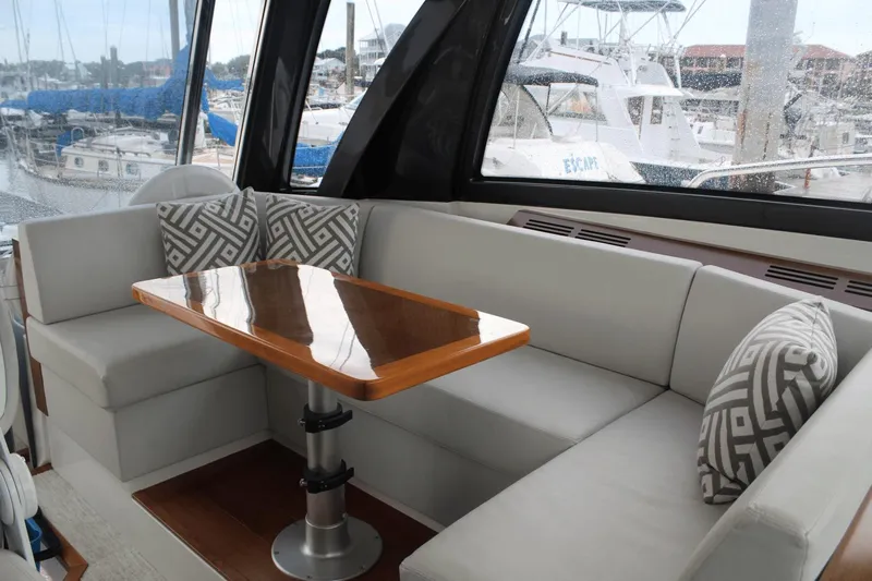 Dream Weaver Yacht Photos Pics Luxurious interior of 2021 Ocean Alexander 45 Divergence Coupe with elegant seating and table.