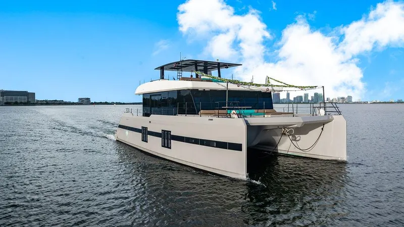 Island Majesty Yacht Photos Pics Luxurious 2018 Sunreef 70 yacht cruising on open water under a clear blue sky.