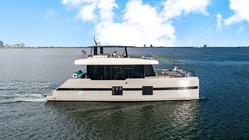 Island Majesty Yacht Photos Pics Luxurious 2018 Sunreef 70 yacht cruising on open water under a clear blue sky.