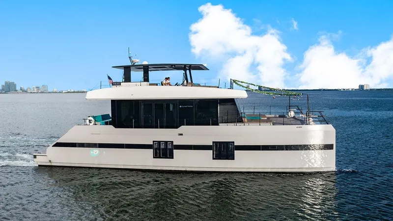 Island Majesty Yacht Photos Pics Luxurious 2018 Sunreef 70 yacht cruising on open water under a clear blue sky.