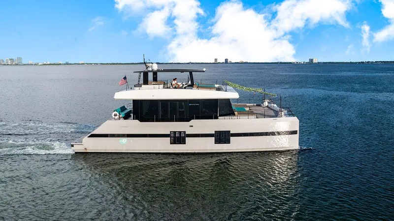 Island Majesty Yacht Photos Pics 2018 Sunreef 70 yacht cruising on open water under a clear blue sky.