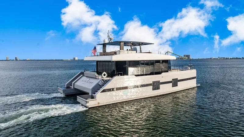 Island Majesty Yacht Photos Pics Luxury Sunreef 70 yacht cruising on open water under a clear blue sky.