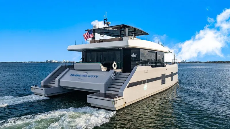 Island Majesty Yacht Photos Pics Luxury Sunreef 70 yacht cruising on open water, 2018 model, clear blue sky.