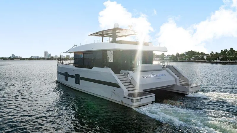 Island Majesty Yacht Photos Pics Luxurious 2018 Sunreef 70 yacht cruising on a sunny day, showcasing sleek design.