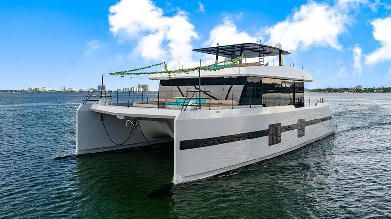 Island Majesty Yacht Photos Pics Luxurious 2018 Sunreef 70 yacht cruising on a sunny day with clear blue skies.