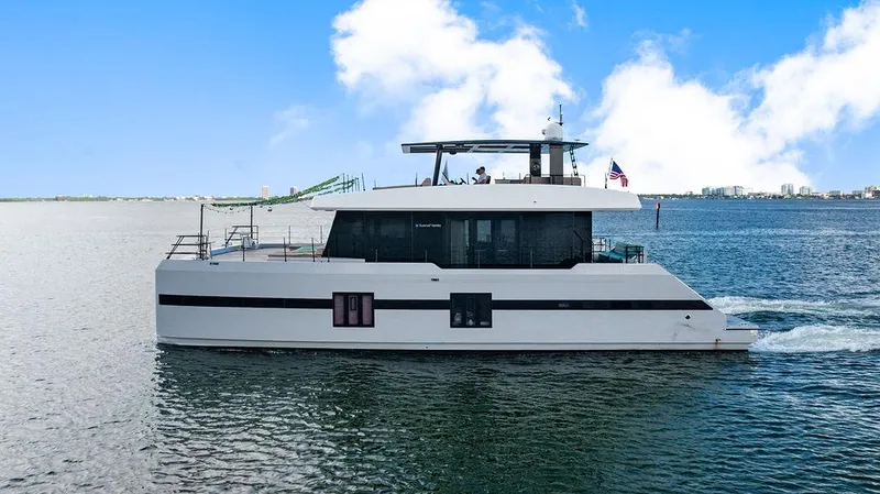 Island Majesty Yacht Photos Pics Luxury Sunreef 70 yacht cruising on open water, 2018 model, under clear blue skies.