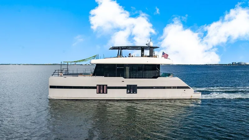 Island Majesty Yacht Photos Pics Luxurious 2018 Sunreef 70 yacht cruising on a sunny day with clear blue skies.