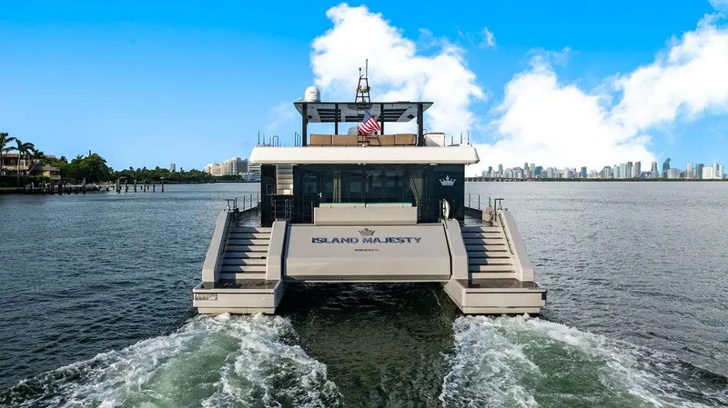 Island Majesty Yacht Photos Pics Luxury Sunreef 70 yacht cruising with city skyline in background, 2018 model.