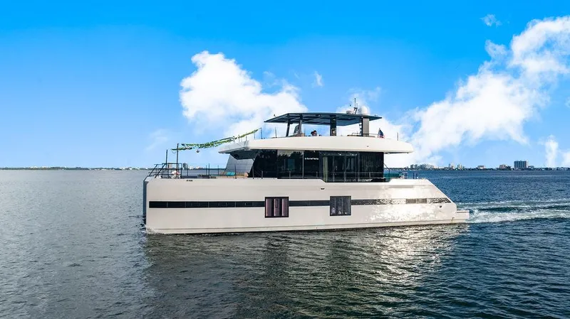 Island Majesty Yacht Photos Pics Luxury Sunreef 70 yacht cruising on open water under a clear blue sky.