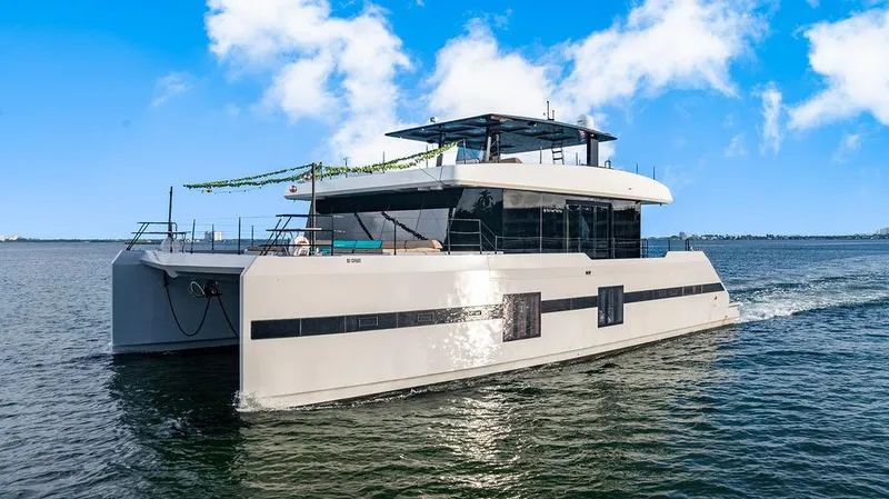 Island Majesty Yacht Photos Pics Luxurious 2018 Sunreef 70 yacht cruising on open water under a clear blue sky.