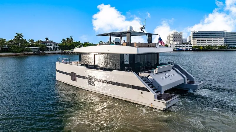 Island Majesty Yacht Photos Pics Luxurious 2018 Sunreef 70 yacht cruising on a sunny day, featuring modern design and spacious deck.