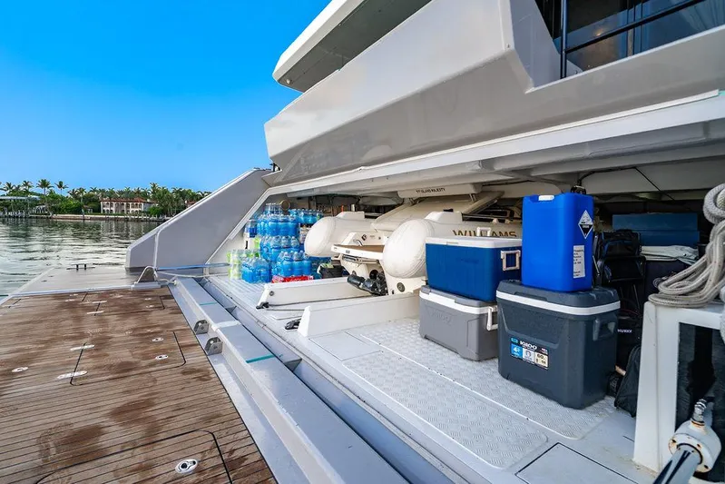 Island Majesty Yacht Photos Pics Storage area on a 2018 Sunreef 70 yacht with coolers and water bottles.