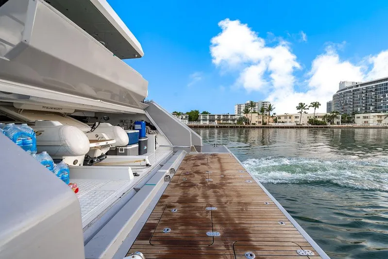 Island Majesty Yacht Photos Pics Luxury Sunreef 70 yacht deck with water view, 2018 model, docked near waterfront buildings.