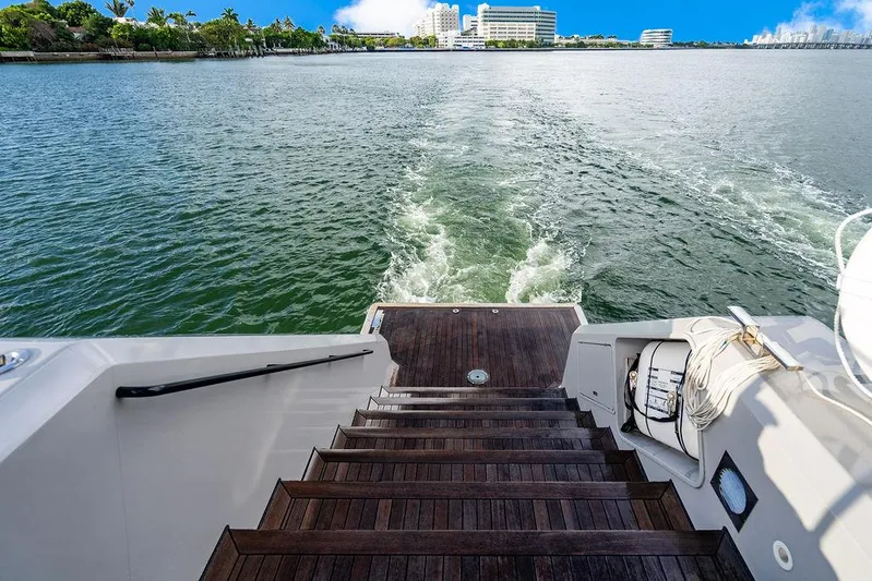 Island Majesty Yacht Photos Pics Staircase on 2018 Sunreef 70 yacht leading to ocean view with city skyline.