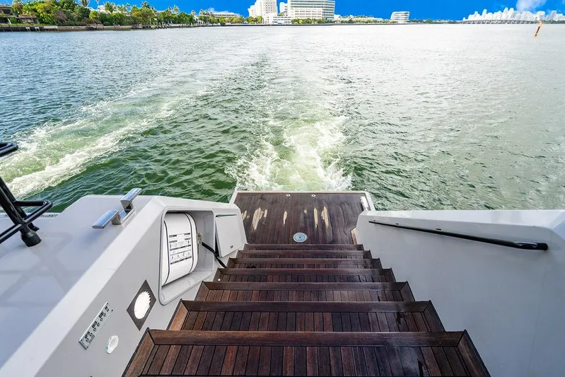 Island Majesty Yacht Photos Pics Stern view of 2018 Sunreef 70 yacht with wooden steps leading to water.