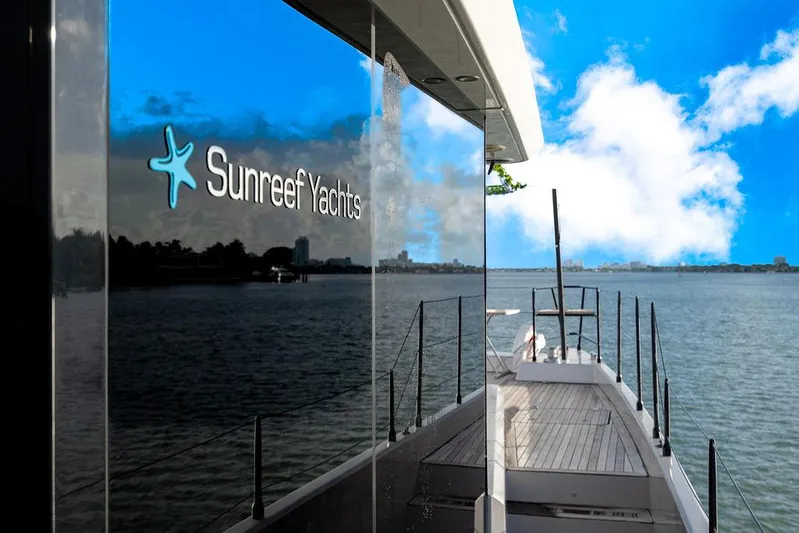Island Majesty Yacht Photos Pics Sunreef 70 yacht reflecting water and sky, showcasing luxury design, 2018 model.