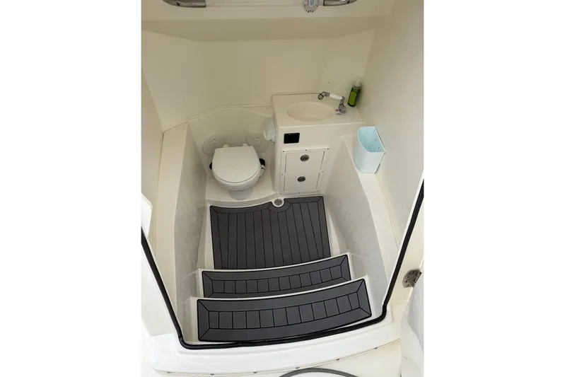  Yacht Photos Pics 2023 Cobia 301 Center Console interior with toilet, sink, and non-slip flooring.