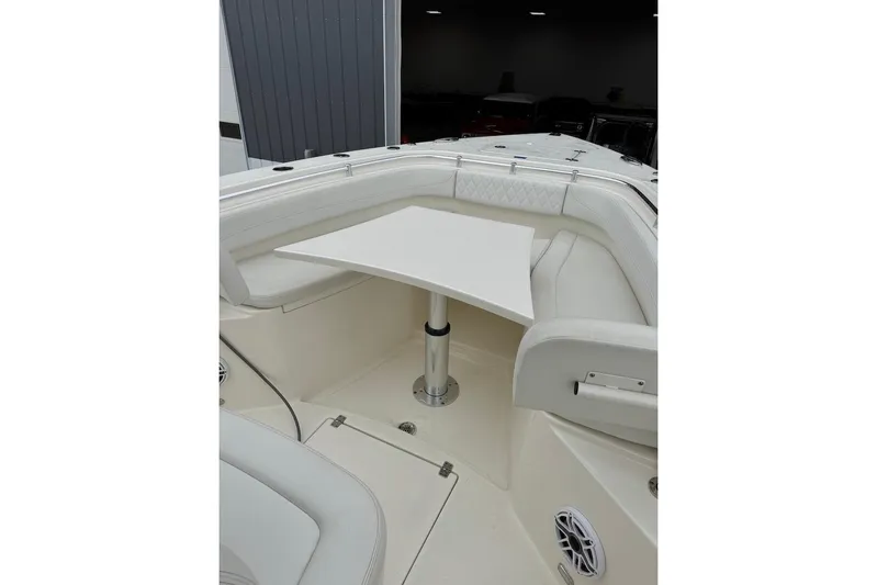  Yacht Photos Pics 2023 Cobia 301 Center Console boat interior with white seating and table.