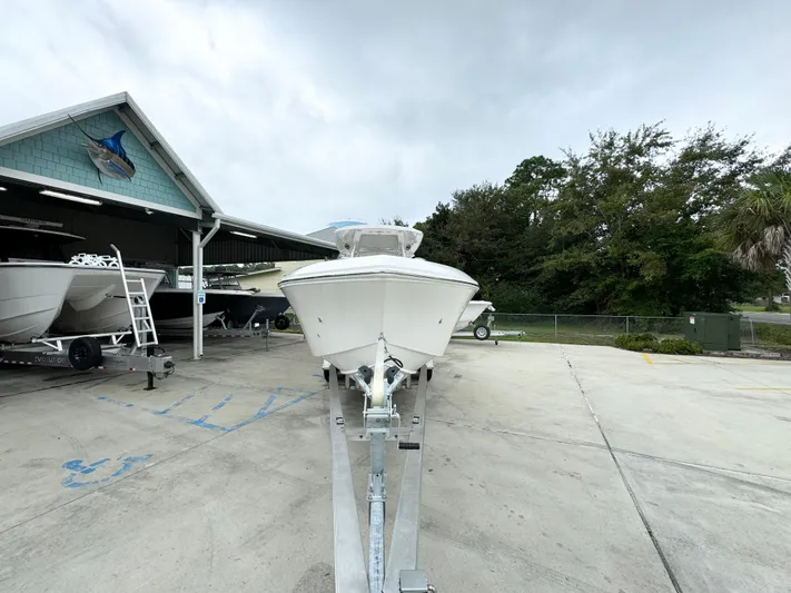  Yacht Photos Pics 2025 Fountain 34TE boat on trailer at marina, overcast sky.
