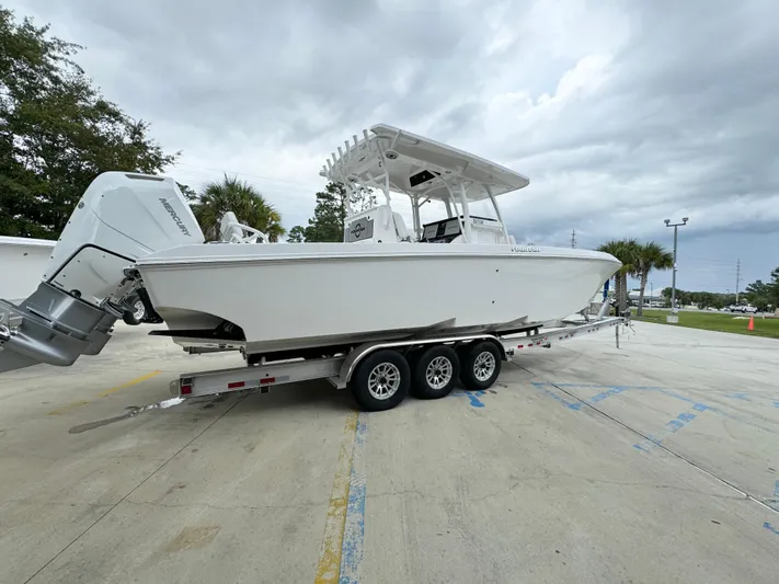  Yacht Photos Pics 2025 Fountain 34TE boat on a trailer in a parking lot.
