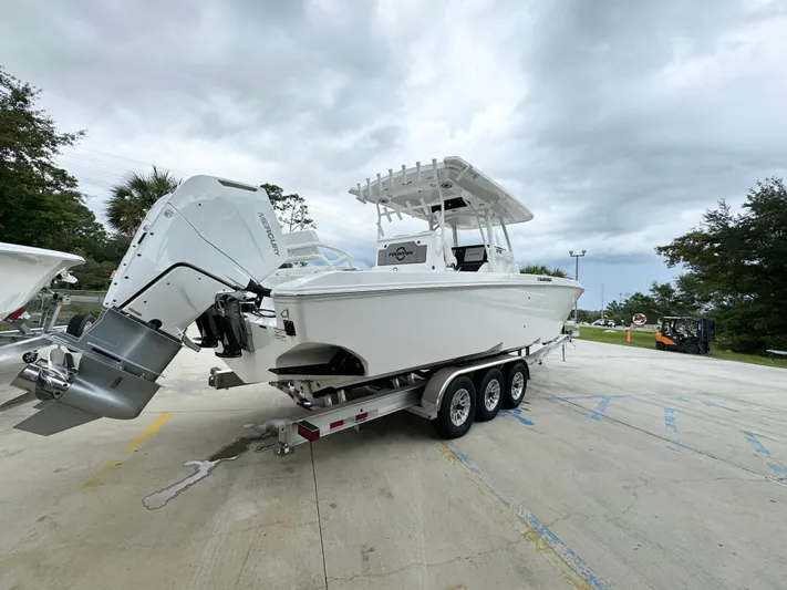  Yacht Photos Pics 2025 Fountain 34TE boat on a trailer, parked outdoors under cloudy skies.