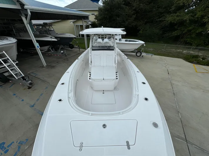  Yacht Photos Pics 2025 Fountain 34TE boat, sleek white design, docked outdoors.