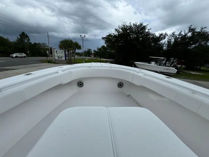  Yacht Photos Pics 2025 Fountain 34TE boat, white interior, parked outdoors under cloudy sky.