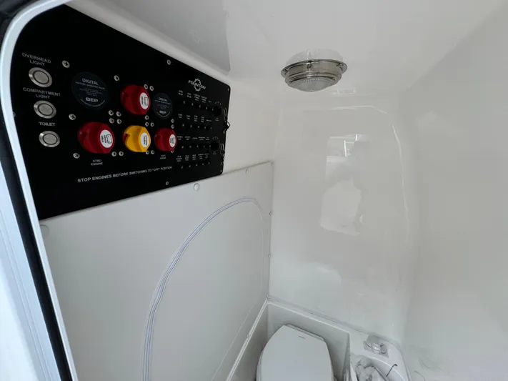  Yacht Photos Pics 2025 Fountain 34TE boat interior with control panel and toilet.
