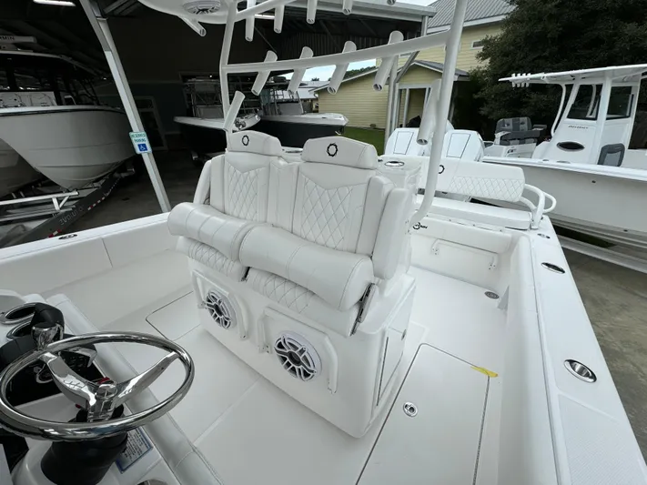  Yacht Photos Pics 2025 Fountain 34TE boat interior with white seating and steering wheel.