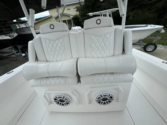  Yacht Photos Pics Luxury seating on 2025 Fountain 34TE boat with diamond stitching and built-in speakers.
