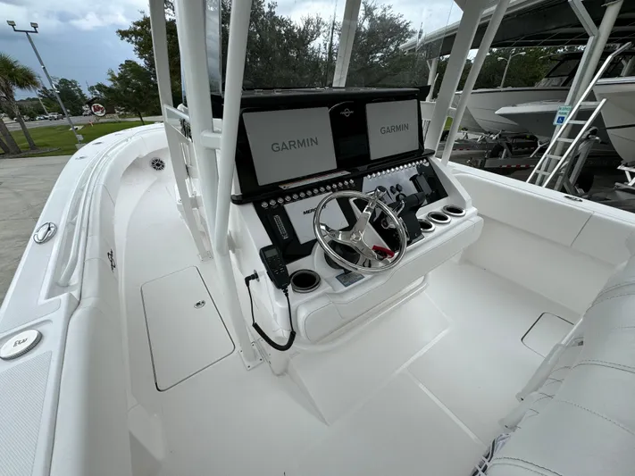  Yacht Photos Pics 2025 Fountain 34TE boat cockpit with Garmin navigation system and sleek white design.