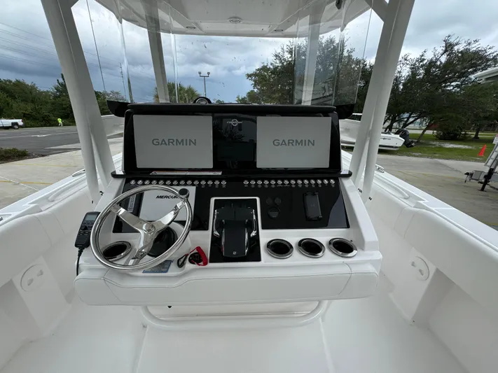  Yacht Photos Pics 2025 Fountain 34TE boat dashboard with Garmin navigation displays and steering wheel.
