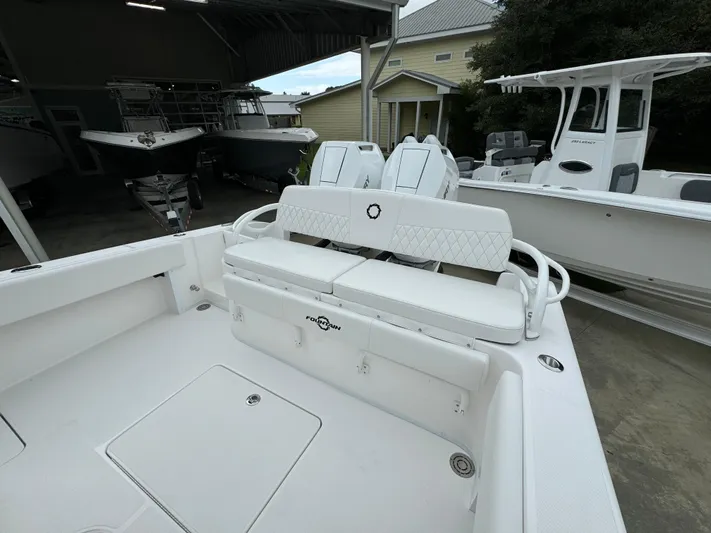  Yacht Photos Pics 2025 Fountain 34TE boat interior with white seating and storage compartments.