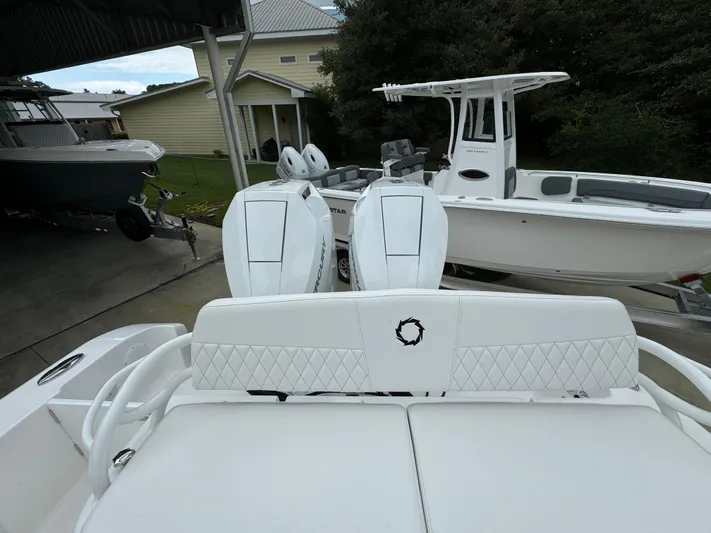 Yacht Photos Pics 2025 Fountain 34TE boat with dual engines, parked outdoors.