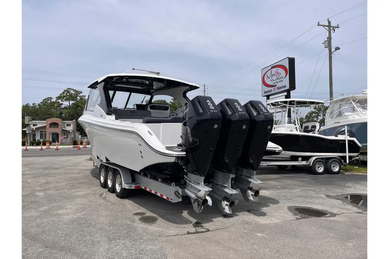  Yacht Photos Pics 2025 Fountain 39 DX boat with triple outboard engines on a trailer at a marina.