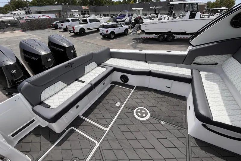  Yacht Photos Pics 2025 Fountain 39 DX boat interior with luxurious seating and Mercury engines in a marina setting.