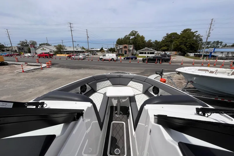  Yacht Photos Pics 2025 Fountain 39 DX boat interior with modern seating, parked near a busy street.