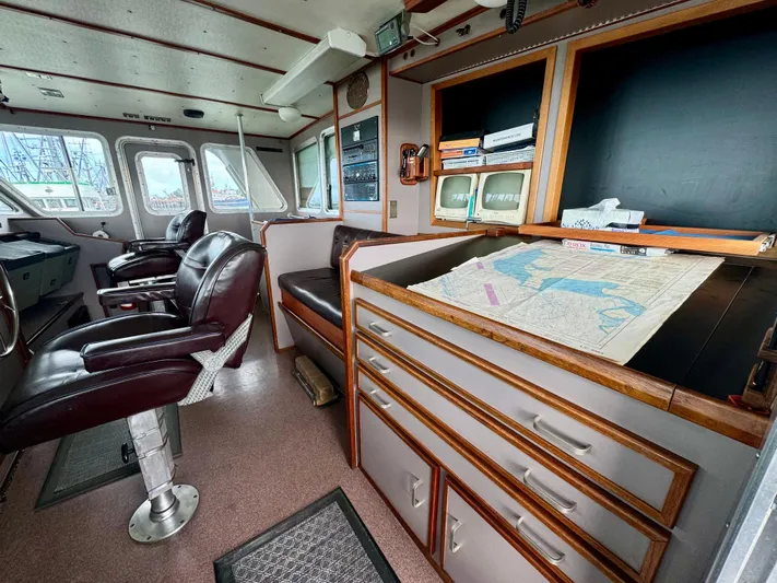 Western Shore Yacht Photos Pics Bridge interior of 1989 Custom Expedition Yacht with navigation map and leather chairs.