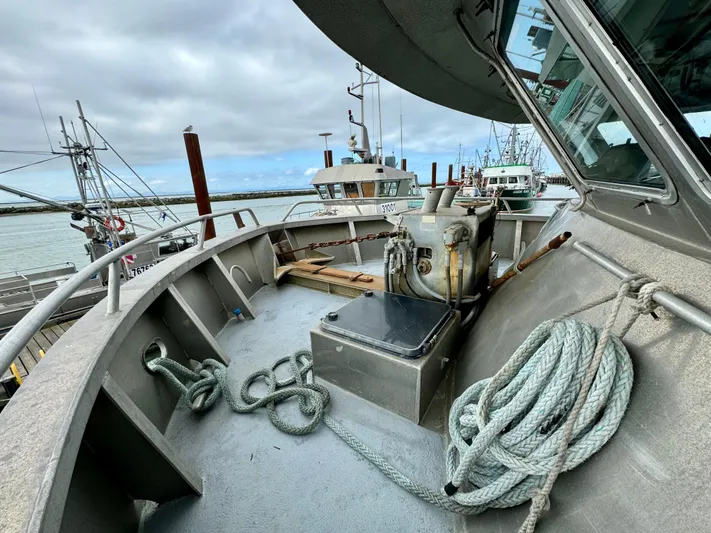 Western Shore Yacht Photos Pics 1989 Custom Expedition Yacht deck with ropes and equipment, docked at a marina.