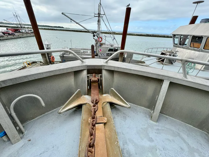 Western Shore Yacht Photos Pics Bow of 1989 Custom Expedition Yacht with anchor chain, docked in a marina.
