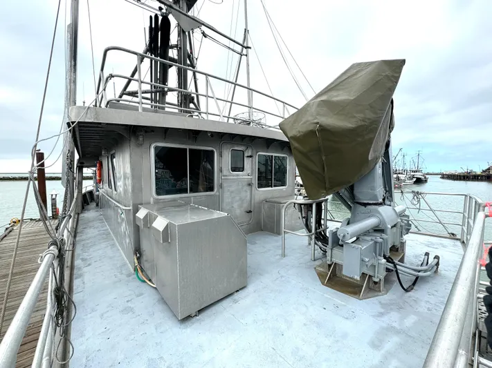 Western Shore Yacht Photos Pics Custom 1989 Expedition Yacht docked, featuring a sturdy metal structure and covered equipment.