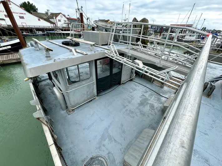 Western Shore Yacht Photos Pics 1989 Custom Expedition Yacht with metal deck and railing, docked in a marina.