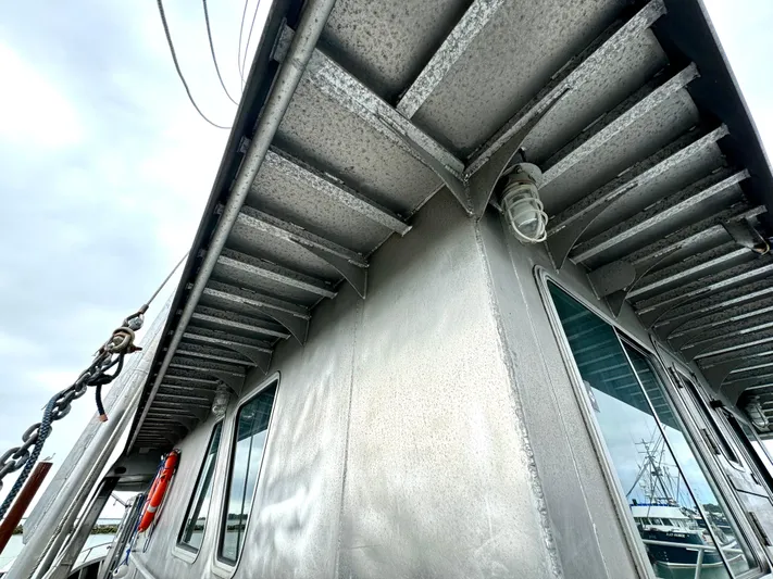 Western Shore Yacht Photos Pics 1989 Custom Expedition Yacht with metal exterior and windows, docked under cloudy skies.