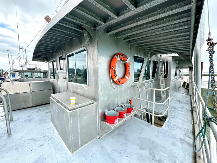 Western Shore Yacht Photos Pics 1989 Custom Expedition Yacht deck with life ring and metal structure.