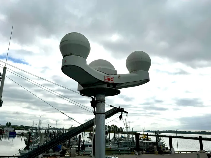 Western Shore Yacht Photos Pics Radar equipment on a 1989 Custom Expedition Yacht at a marina under cloudy skies.