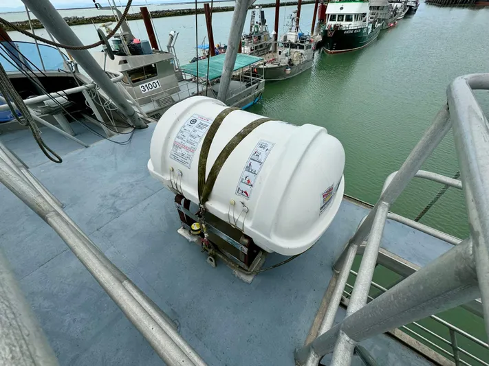 Western Shore Yacht Photos Pics Life raft on 1989 Custom Expedition Yacht deck, docked at marina.
