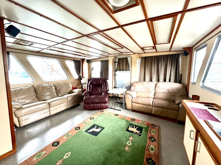 Western Shore Yacht Photos Pics Spacious 1989 Custom Expedition Yacht interior with leather sofas and large windows.