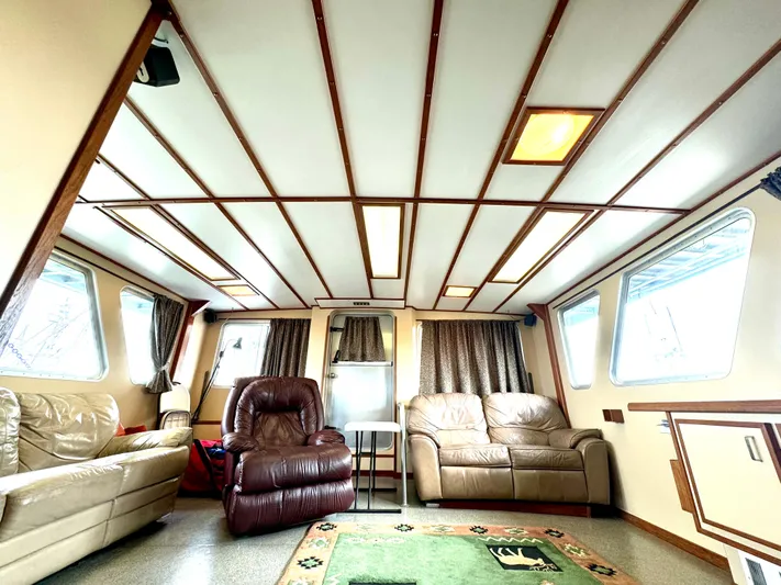 Western Shore Yacht Photos Pics Luxurious interior of a 1989 custom expedition yacht with leather seating and large windows.