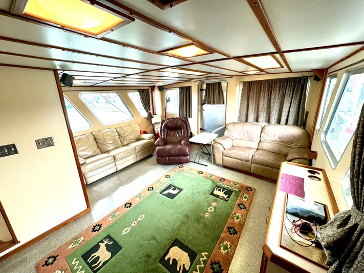 Western Shore Yacht Photos Pics Luxurious 1989 Custom Expedition Yacht interior with cozy seating and wildlife-themed decor.