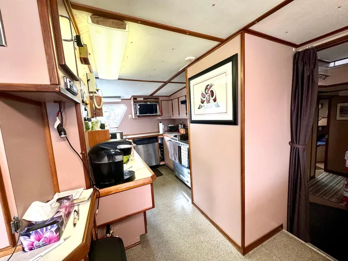 Western Shore Yacht Photos Pics Interior of a 1989 Custom Expedition Yacht with modern kitchen amenities and cozy decor.